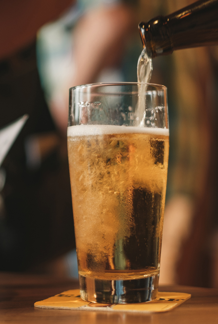 A pint of lager being poured
